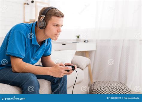 Concentrated Guy Playing Video Game With Joystick Stock Photo Image
