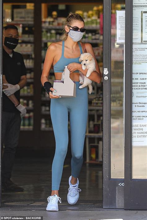 Kaia Gerber Flaunts Her Midriff In Sports Bra And Leggings While Carrying One Of Her Foster Pups