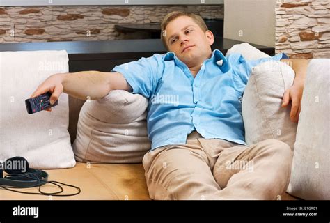Man Lying On Sofa Watching Tv At Home Stock Photo Alamy