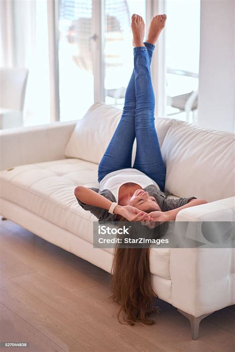 Beautiful Young Woman Lying Upside Down On Couch Stock Photo Download