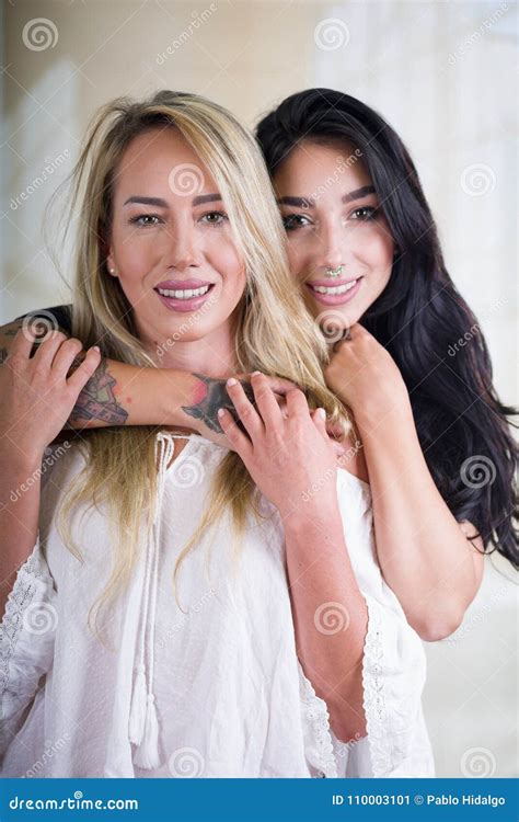 Close Up Of A Lesbians Lovers In A Room At Morning And Brunette Woman Is Hugging Her Girlfriend