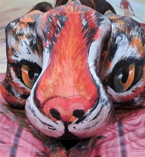 Three Models With Their Bodies Painted Form A 3d Image Of A Tiger