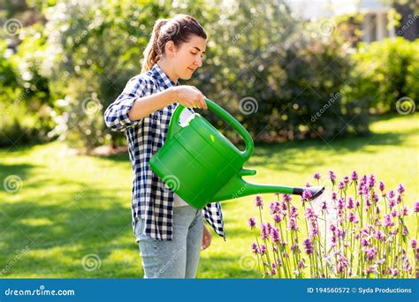 Young Woman Watering Flowers At Garden Stock Photo Image Of Natural