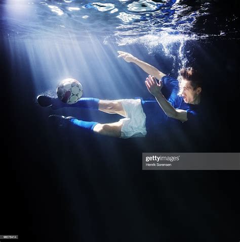 Male Soccer Player Kicking Ball Underwater High Res Stock Photo Getty