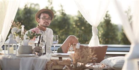 Lifestyle Man Sitting And Wait Romantic Dinner Outdoor Resort Stock