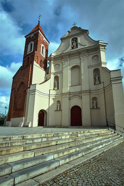 Baroque Facade Of The Church With A Gothic Bell Tower Stock Photo