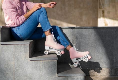 Free Photo Side View Of Woman In Jeans On Stairs With Roller Skates