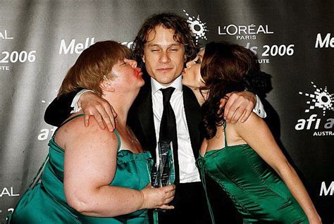 Two Women And A Man Kissing On The Red Carpet At An Awards Event In 2009