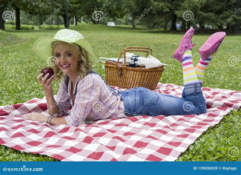 Attractive Young Blond Woman Posing Outdoors During Picnic Stock Image