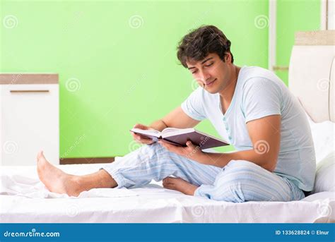 The Young Handsome Student Reading Book In The Bed Stock Photo Image