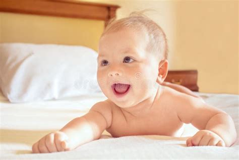 Portrait Of A Baby Lying On Stomach On The Bed Stock Photo Image Of