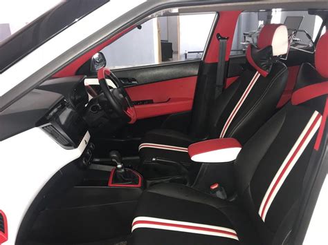 the interior of a car with red and black seats