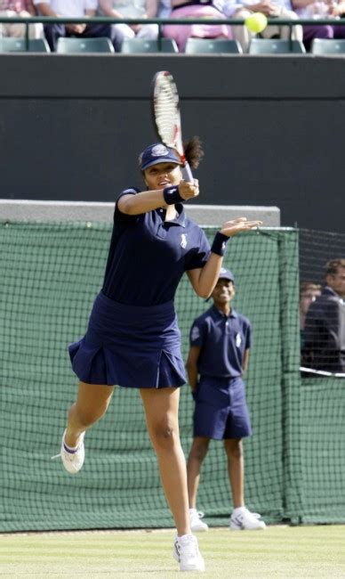 smash and volley one ballgirl provides landing mat for 6ft 3in tennis star while another enjoys