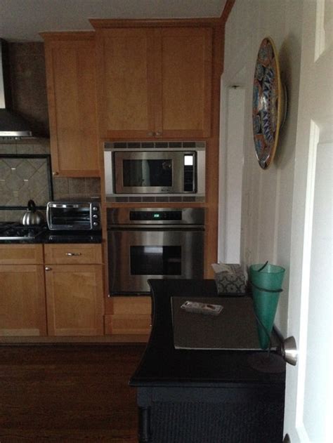 No need for trim tile under cabinets if backsplash goes right to the top. trim color in kitchen- wood trim top of cabinets meet wall ...