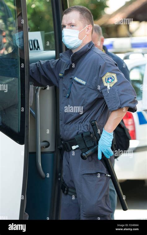 Brezice Slovenia 19th Sep 2015 A Slovenian Policeman Escorts Refugees To Refugee Center In
