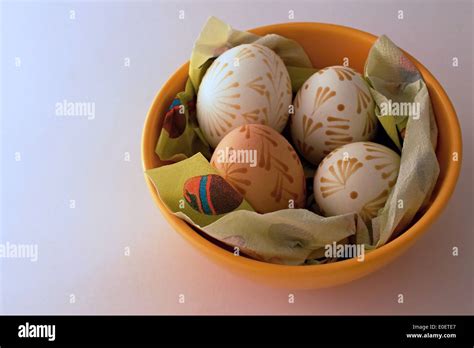 Four Easter Eggs In Orange Dish Stock Photo Alamy