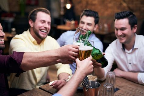 Premium Photo Group Of Men Making A Cheers At The Bar