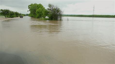 Cars Driving On Flooded Road During A Flood Caused By Heavy Rain