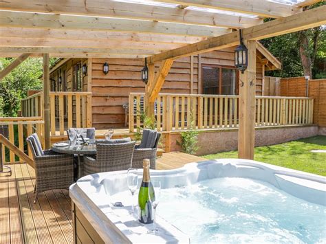 Outside the cabin, there is a hot tub perfect for relaxing during romantic getaways. 2 bed Log cabin in Washford - 10465212 - ELM LODGE, hot ...