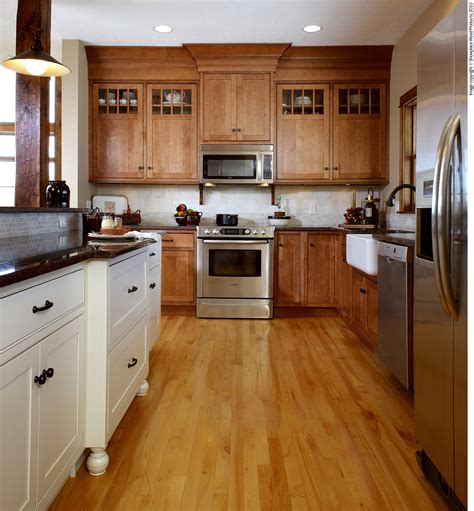 A frequent iteration of the look includes a darker color for the lower cabinets and a lighter shade for shelves that sit higher up. Is Mixing Kitchen Cabinet Finishes Okay or Not?