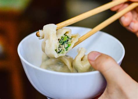 Pour in water then place a small bowl in the middle. Chopsticks Pick Up An Opened Chinese Dumpling From A Bowl Stock Image - Image of asia, cooking ...