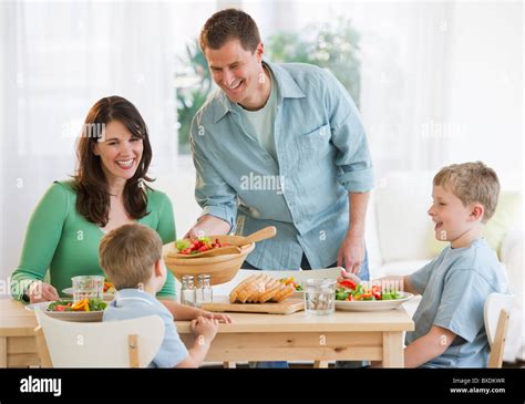 Family eating dinner Stock Photo - Alamy
