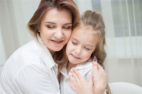 Happy Mother And Daughter Are Hugging At Home Stock Photo Download