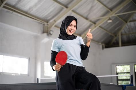 Premium Photo Beautiful Athlete In Hijab Holding Paddle With Thumbs