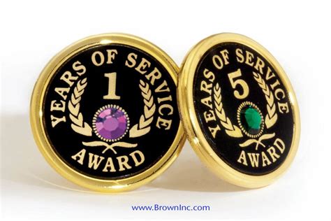 Two Black And Gold Colored Coins With The Words Year Of Service Award On Them