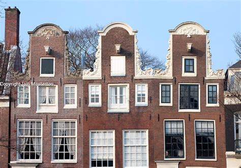 Traditional Historic Dutch Gable Houses Beside Canal In Amsterdam The Netherlands Iain