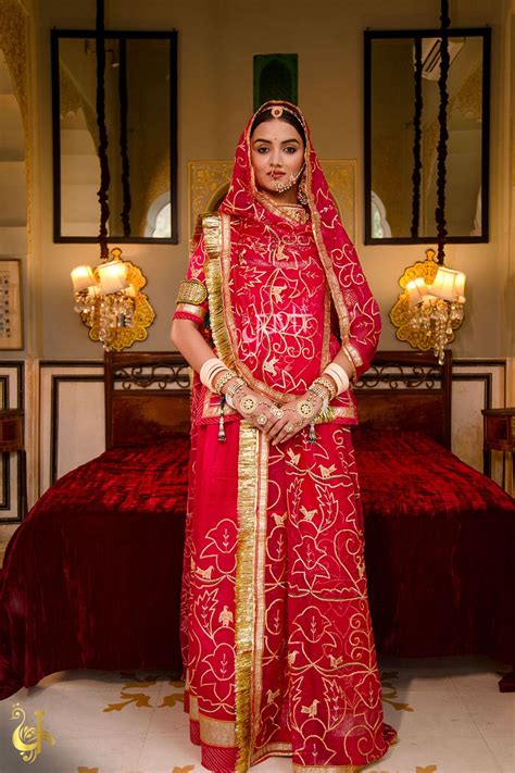 A Curation Of Elegance With Graceful Motifs Dipped In The Majestic Red Hued Ensemble Art