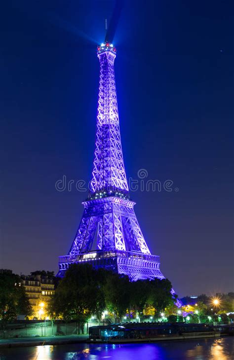 The Eiffel Tower Lit Up In Purple Color At Night Paris France