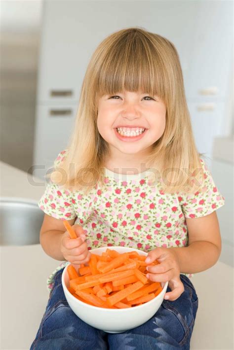 Young Girl Eating Bowl Of Carrots Stock Image Colourbox