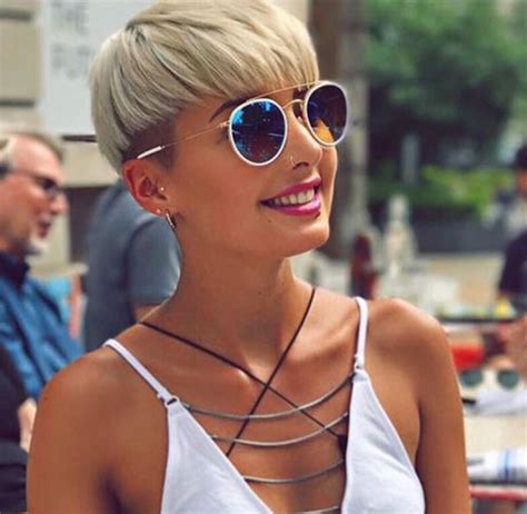 Choppy layers add trendy texture at the back and fit well with cute and quirky balloon tattoos on the model's neck. Super Short Blonde Pixie Cuts - The UnderCut