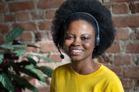 Happy Black Woman With Headset Posing Over Brick Wall Look At Camera