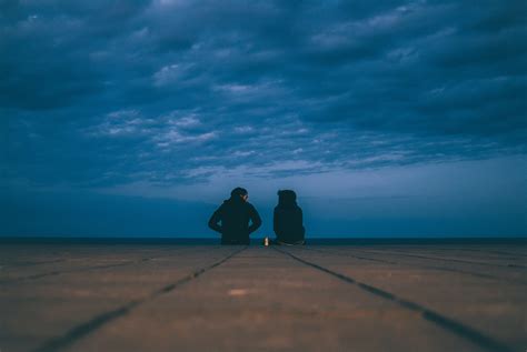 Wallpaper Id 215488 A Couple Sitting Down Under A Stormy Cloudy Sky