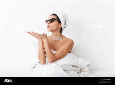 Image Of A Beautiful Woman With Towel On Head Lies In Bed Under Blanket