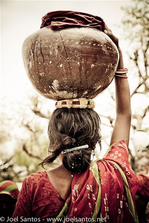 Carrying The Load A Women In India Carrying Water In A Pot Balanced On