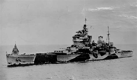 An Old Photo Of A Battleship In The Water