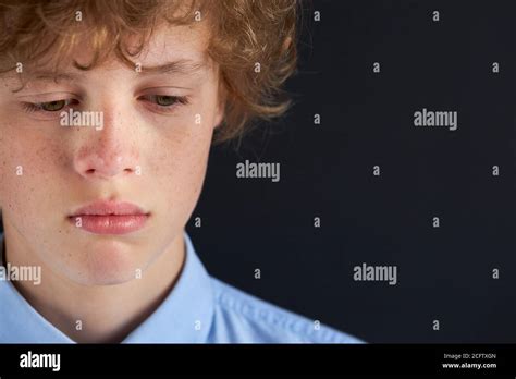 Close Up Portrait Of Sad Caucasian Boy Looking Down Depressed Boy Has