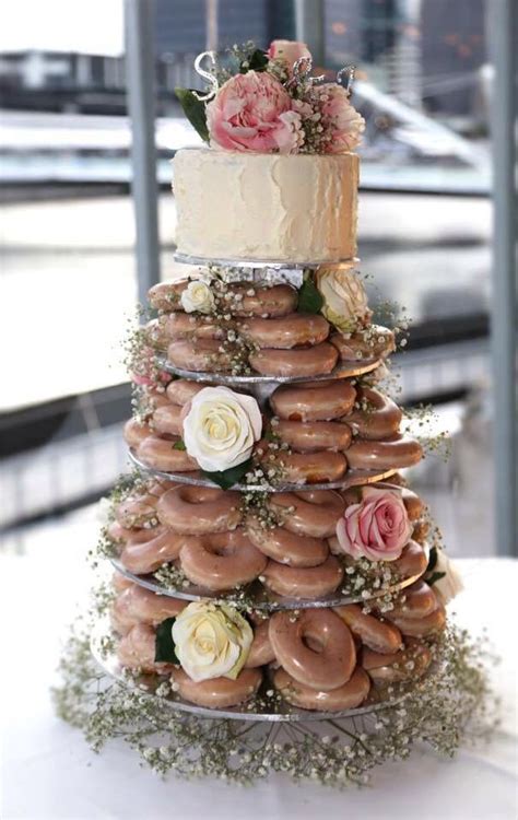 A Wedding Cake Made Out Of Doughnuts And Flowers
