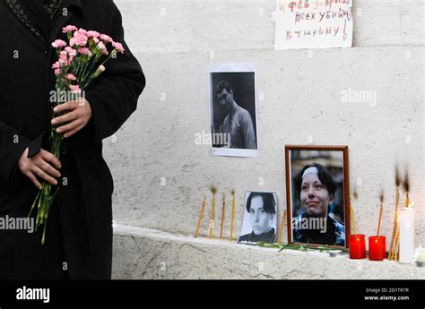A Person Lays Flowers At The Site Where Lawyer Stanislav Markelov And