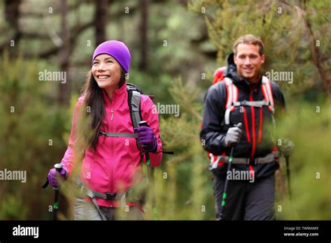 Hiking People Hikers Trekking In Forest On Hike Couple On Adventure Trek In Beautiful Forest