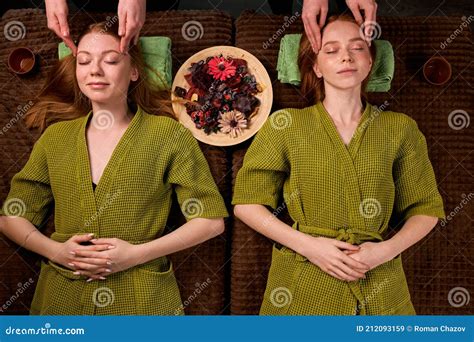 Professional Massage Therapist Gives Head Massage To Two Women Stock