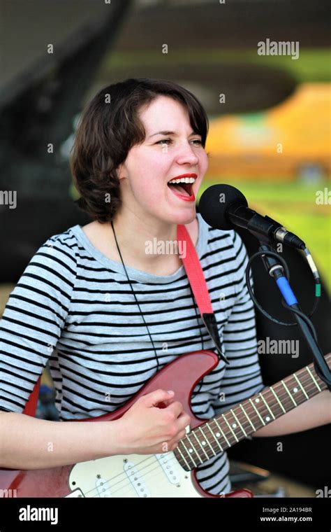 Woman Singer Playing Electric Guitar At The Open Air Stage Stock Photo