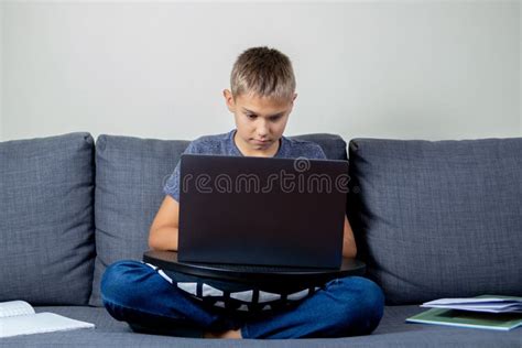 Child Using Laptop Computer At Home For Online Learning Homework
