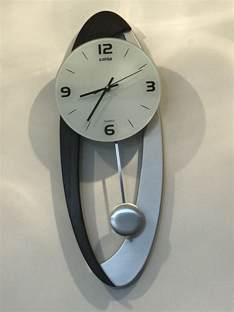 Pendulum clocks have been used to keep time since 1656. Modern Wall Clock Pendulum Carved Hanging Unique Oval ...