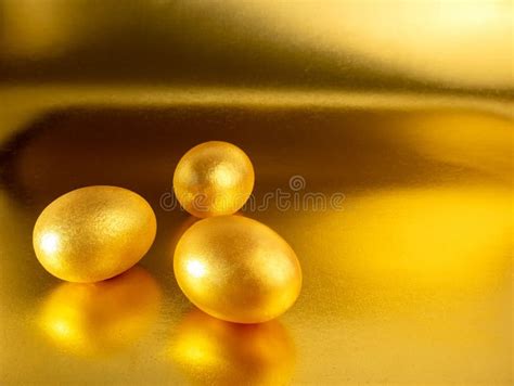 Three Easter Eggs Painted In Gold On A Glittering Background For The