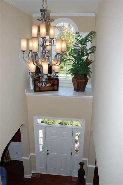 How to make shelves for the inside of your cabinet doors. two story foyer with shelf above door with window. What ...