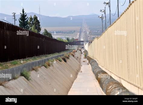 A Culvert Runs Along The International Border Wall Between Agua Prieta